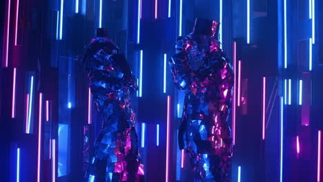 Two-people-a-man-and-a-woman-dance-in-reflective-shiny-costumes-against-a-neon-wall.